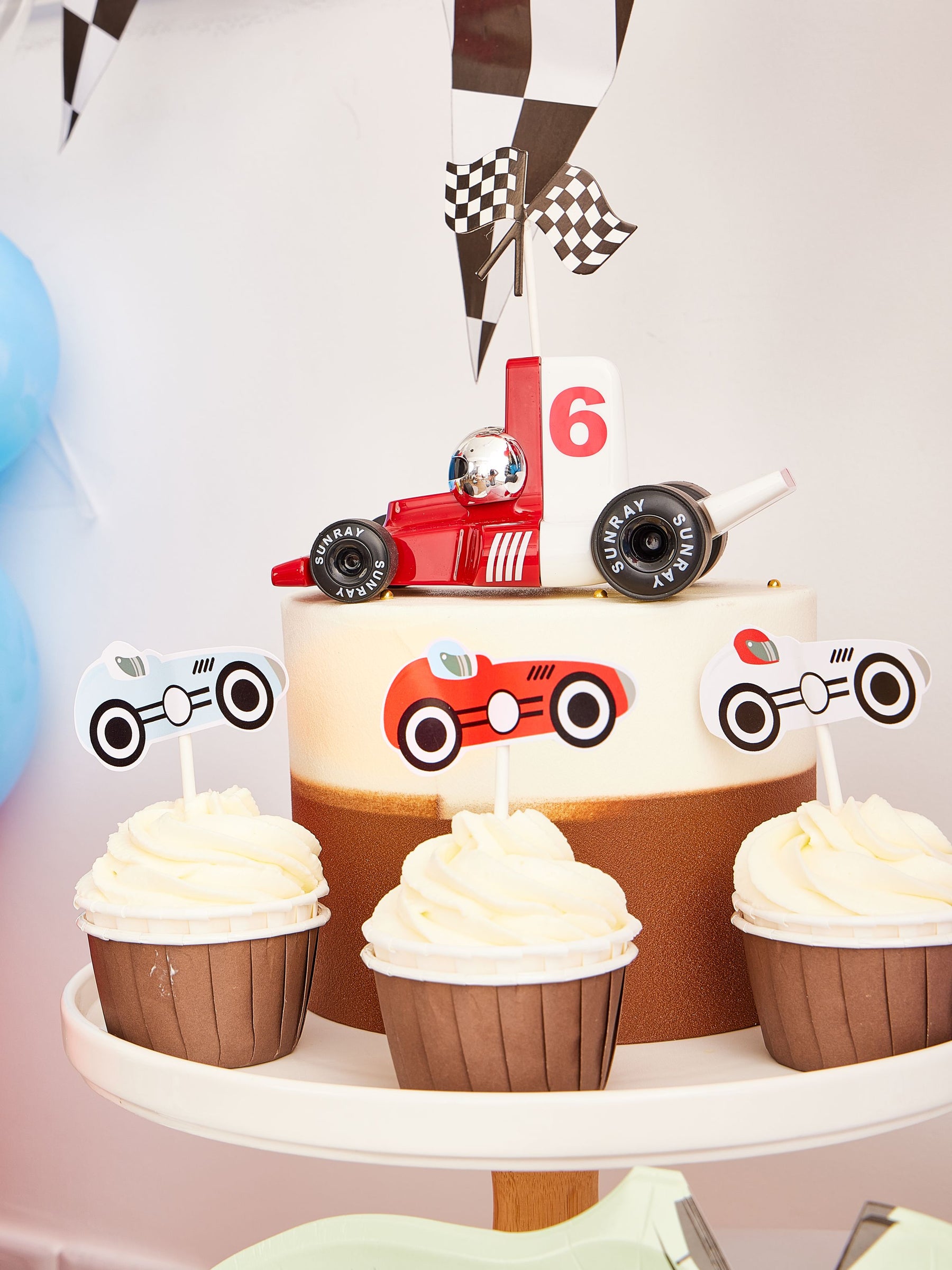 Pekaboay Race Car Themed Children’s Party Supply Kit including cups, cupcake toppers, cutlery, banners, foil balloon, balloon garland, straws, napkins, 7-inch plates, and 9-inch plates