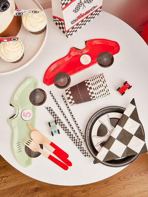 Pekaboay Race Car Themed Children’s Party Supply Kit including cups, cupcake toppers, cutlery, banners, foil balloon, balloon garland, straws, napkins, 7-inch plates, and 9-inch plates